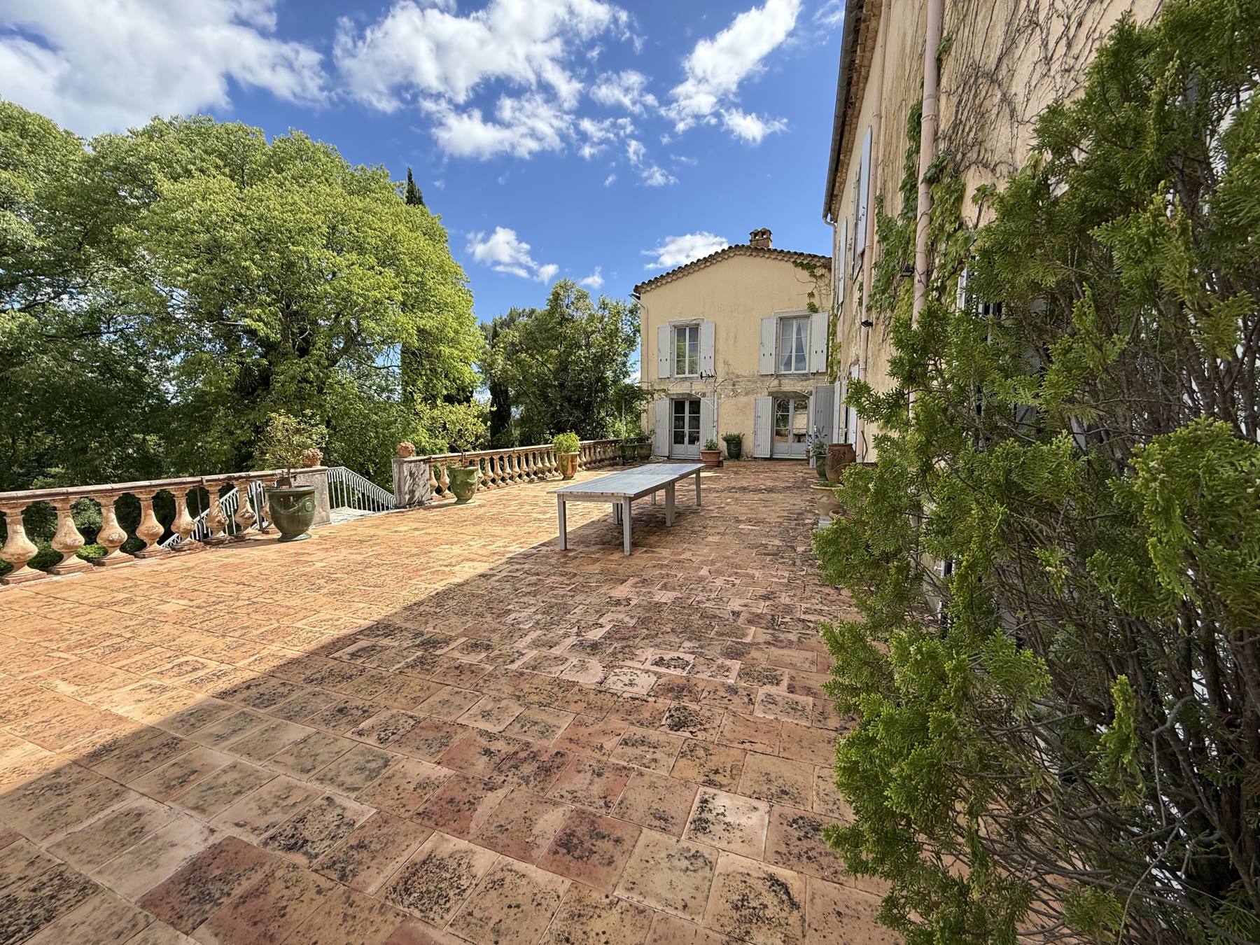 La grande terrasse à balustres du château, entourée d'arbres